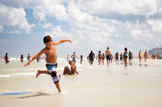 Boy running happily at beach