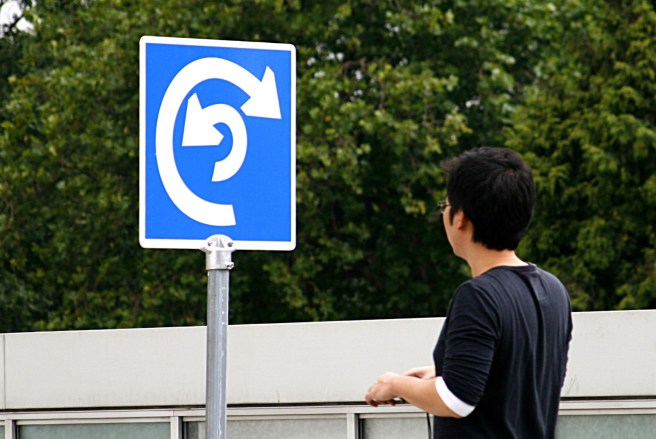 Man looking at confusing sign