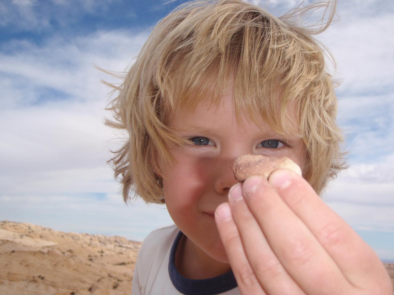 Boy stares at pebble, the power of attention